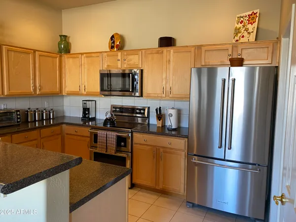 a kitchen with stainless steel appliances a refrigerator sink and microwave