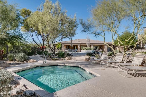 a view of a house with garden and sitting area