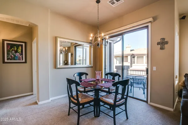 a view of a dining room with furniture and window