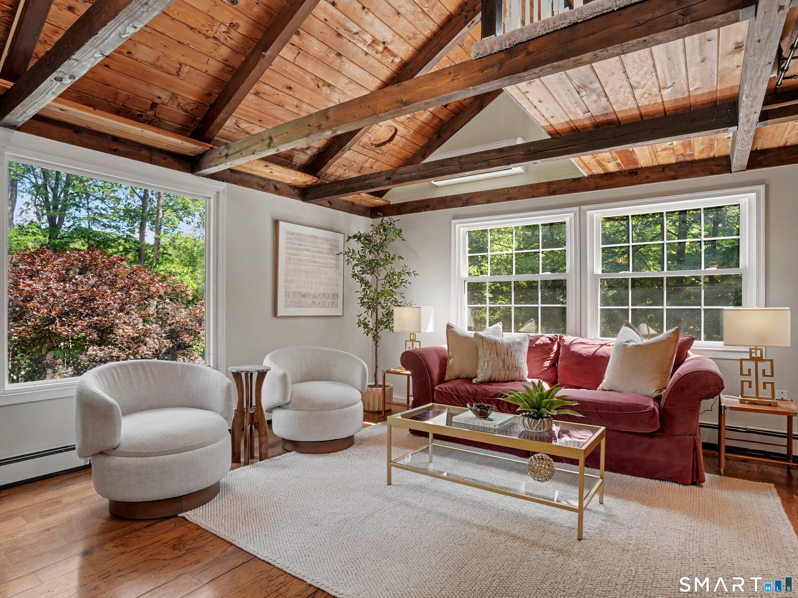 252 Bennetts Farm Road Ridgefield, CT 06877 - Photo 5 of 40 The Living Room is a sanctuary, featuring large windows that overlook the the private wooded surroundings & maximize natural light.