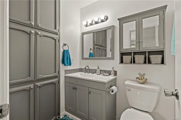 a bathroom with a toilet a sink and mirror