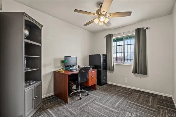 a view of a workspace with furniture and a window