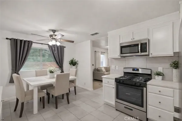 a kitchen with a stove and a white cabinets