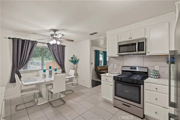 a kitchen with a stove a sink and a microwave