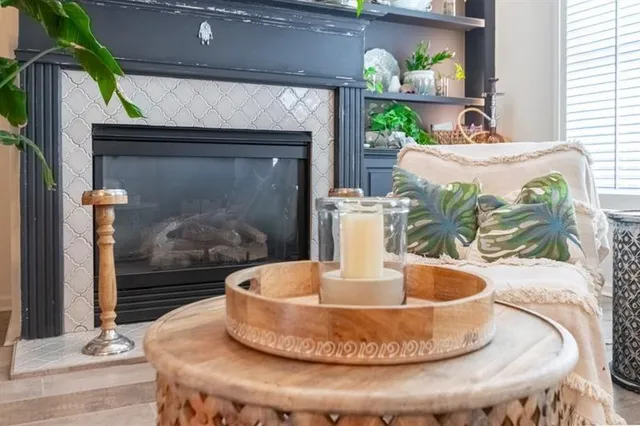 a living room with furniture flowerpot and wooden floor