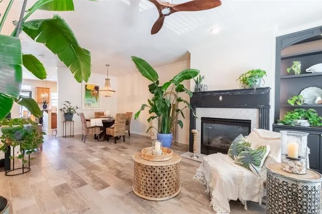 a dining room with furniture potted plants and wooden floor