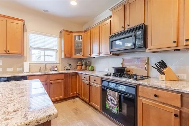 a kitchen with sink refrigerator dining table and chairs