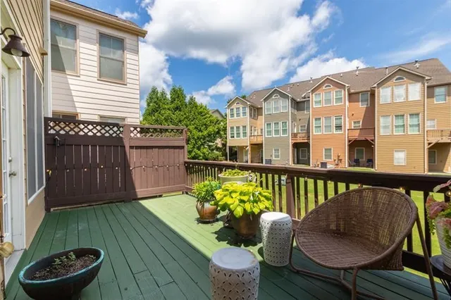 a bedroom with a bed dresser and a flat tv screen