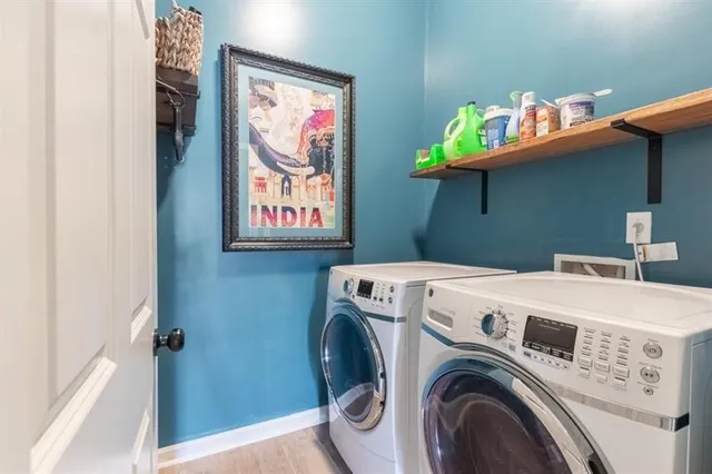 a spacious bathroom with a double vanity sink a large mirror and a bathtub
