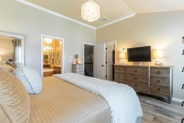 a bedroom with a large bed and a window