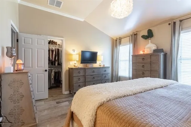 a bed room with a bed and a dresser