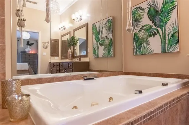 a view of a porch with potted plants and floor to ceiling window