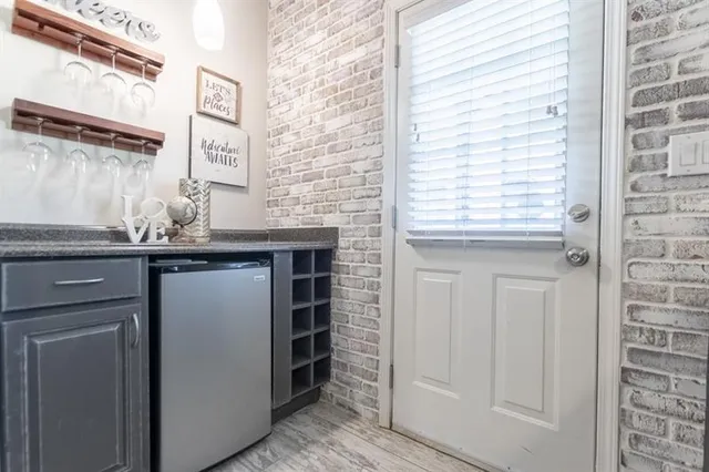 a tennis court that has trees in the background