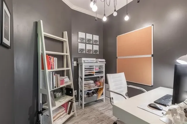 a view of staircase with wooden floor and painting on the wall