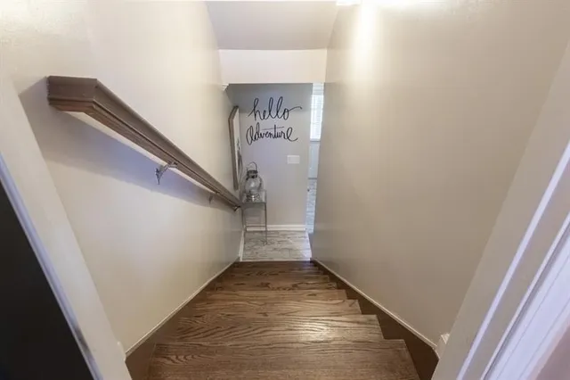 a living room with furniture a window and a potted plant