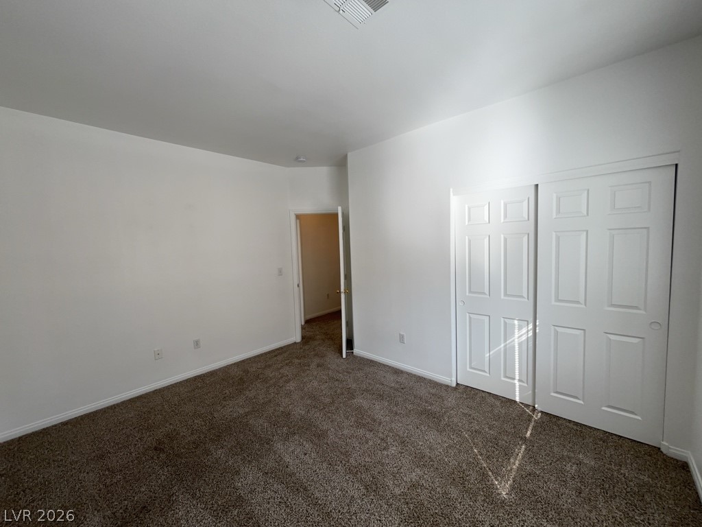 4915 East Russell Road, Unit 142 Las Vegas, NV 89120 - Photo 5 of 10 A spacious bedroom provides comfort with plush carpeting and ample closet space.