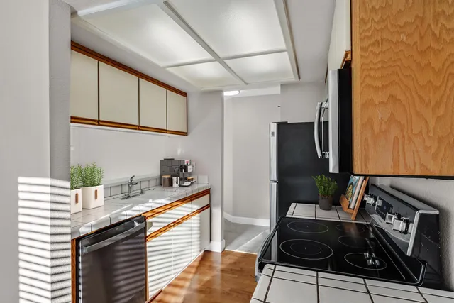 a kitchen with stainless steel appliances a stove a microwave and cabinets