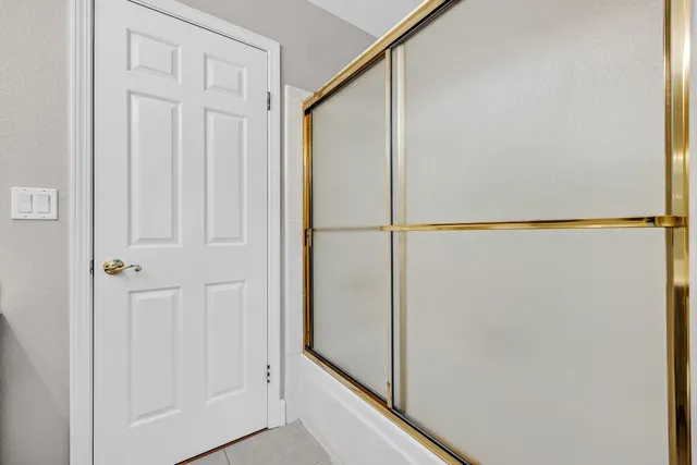 a front view of a building with a garden and trees