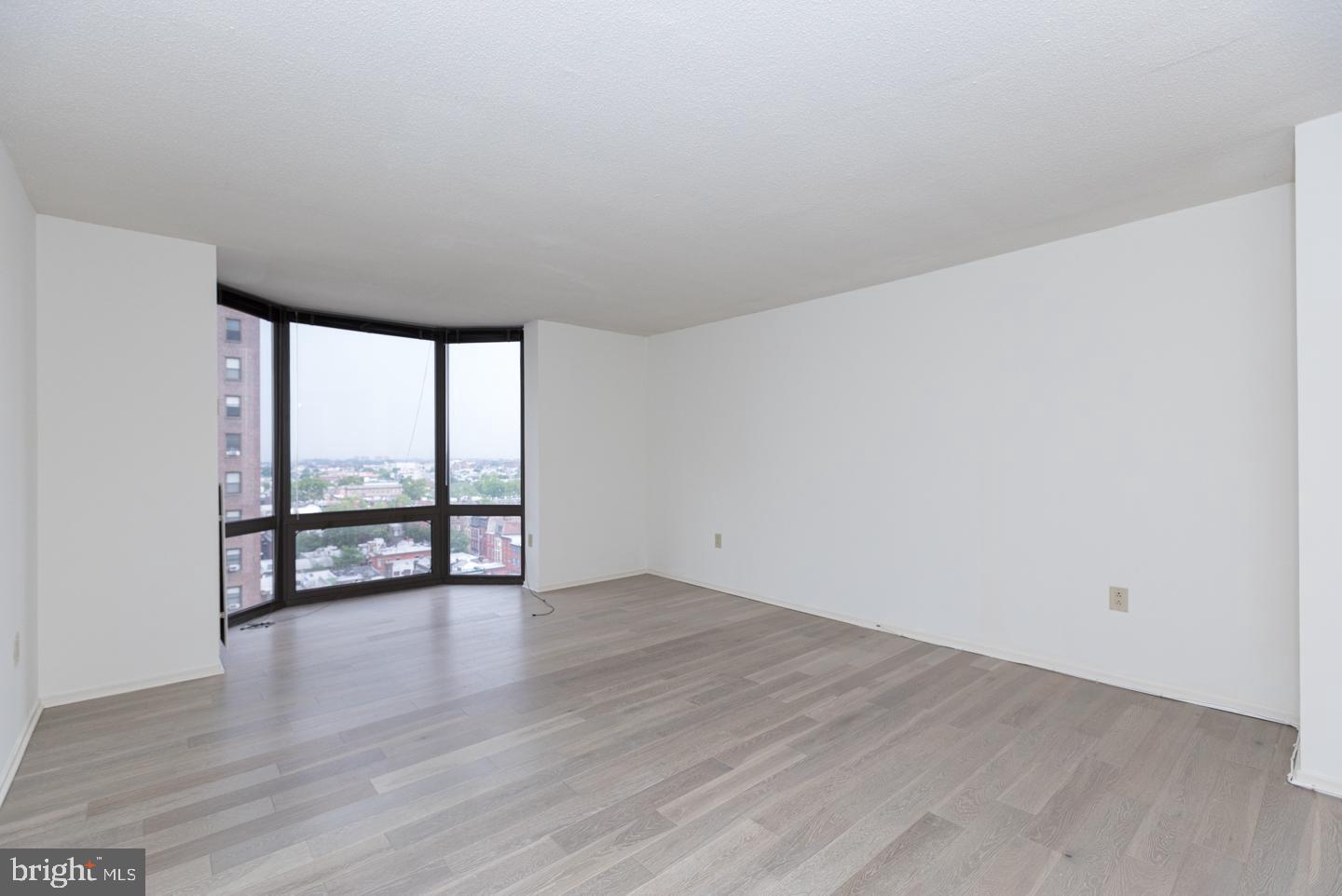 2020 Walnut Street, Unit 5M Philadelphia, PA 19103 - Photo 2 of 15 a view of an empty room with wooden floor and iron fence