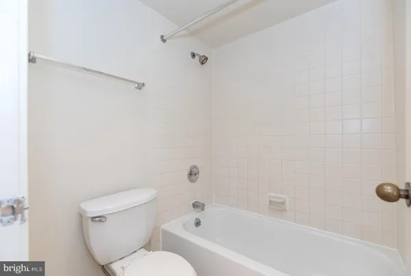 a bathroom with a toilet and a bathtub