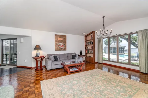 a living room with furniture a rug and a lamp