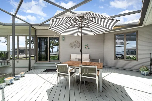 a swimming pool with outdoor seating and yard
