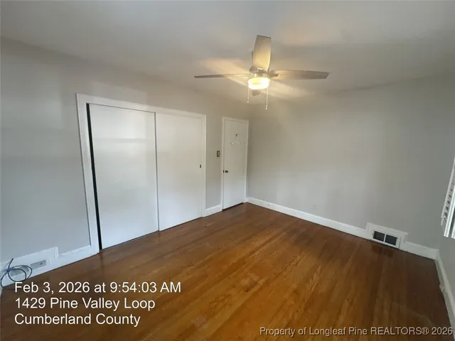 an empty room with a ceiling fan