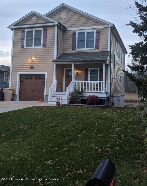 611 Riverside Drive Bayville, NJ 08721 - Photo 1 of 22 a front view of a house with a yard and trees