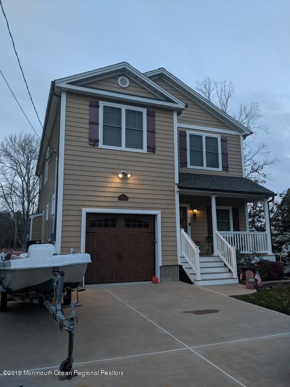 611 Riverside Drive Bayville, NJ 08721 - Photo 2 of 22 a front view of a house with a garage