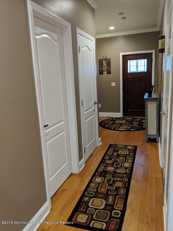 611 Riverside Drive Bayville, NJ 08721 - Photo 13 of 22 a walk in closet and view of bedroom with wooden floor
