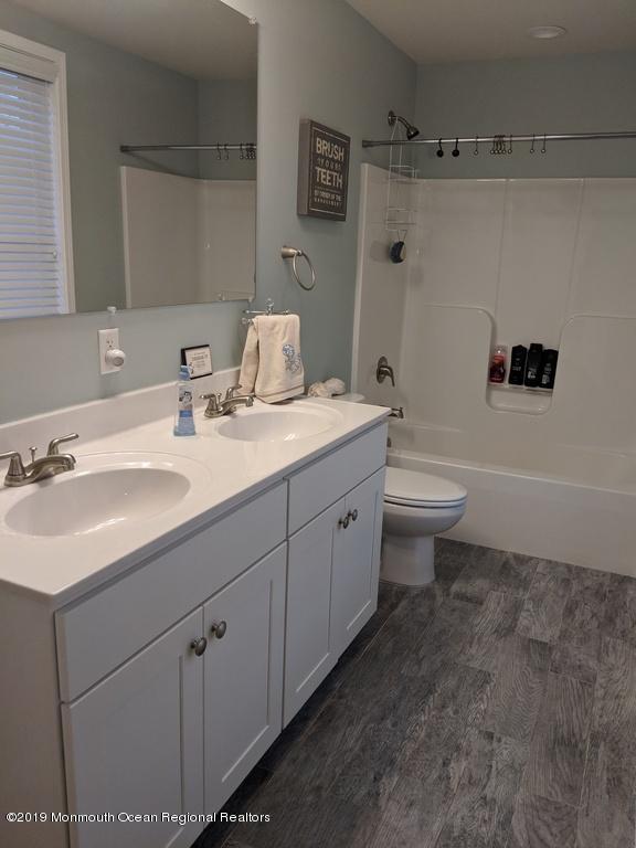 611 Riverside Drive Bayville, NJ 08721 - Photo 14 of 22 a bathroom with a sink toilet vanity and tub