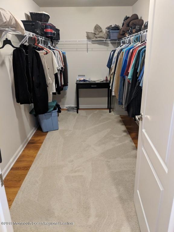 611 Riverside Drive Bayville, NJ 08721 - Photo 17 of 22 a view of walk in closet with clothes and shoes