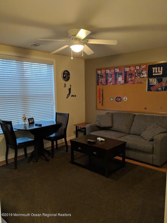 611 Riverside Drive Bayville, NJ 08721 - Photo 21 of 22 a living room with furniture a rug and a wall painting