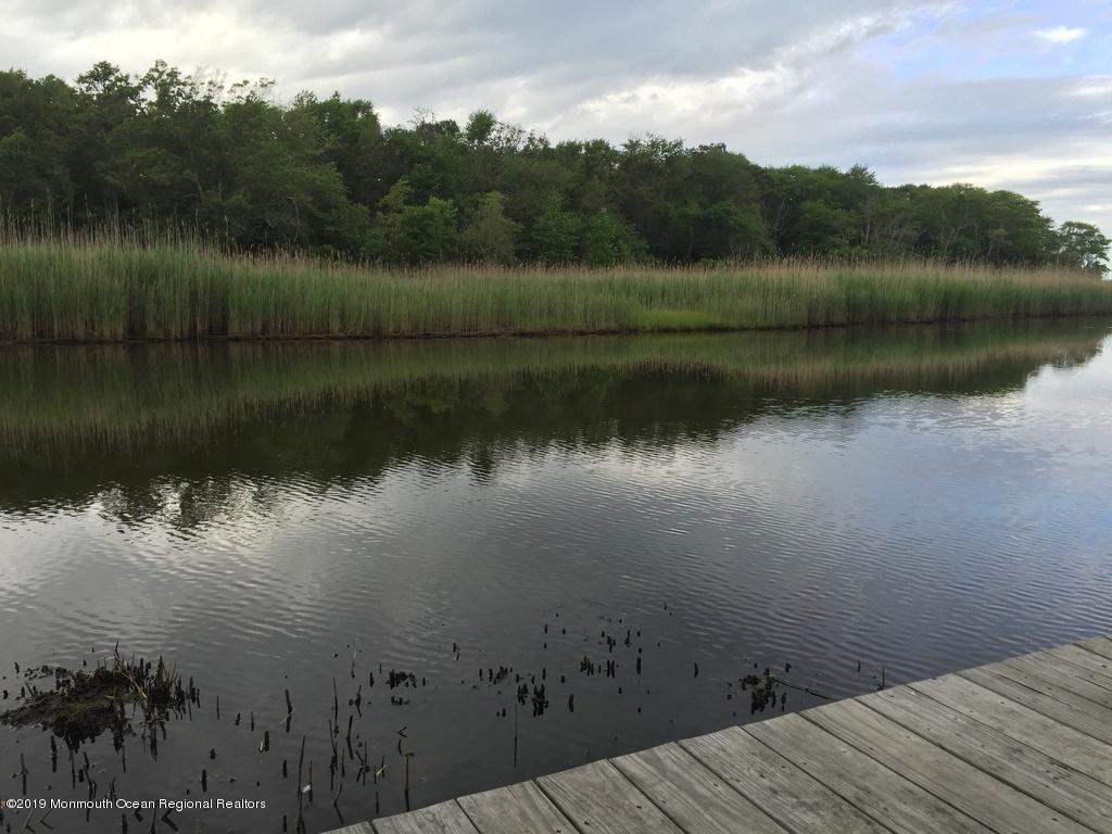611 Riverside Drive Bayville, NJ 08721 - Photo 4 of 22 a view of a lake in between two of trees
