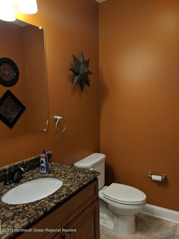 611 Riverside Drive Bayville, NJ 08721 - Photo 10 of 22 a bathroom with a granite countertop sink and a mirror