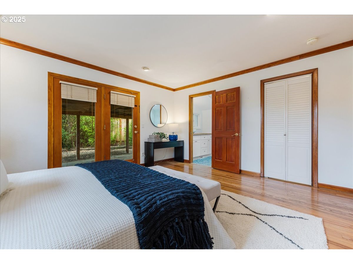 11805 Southwest Belvidere Place Portland, OR 97225 - Photo 18 of 44 a bedroom with a bed and a large window