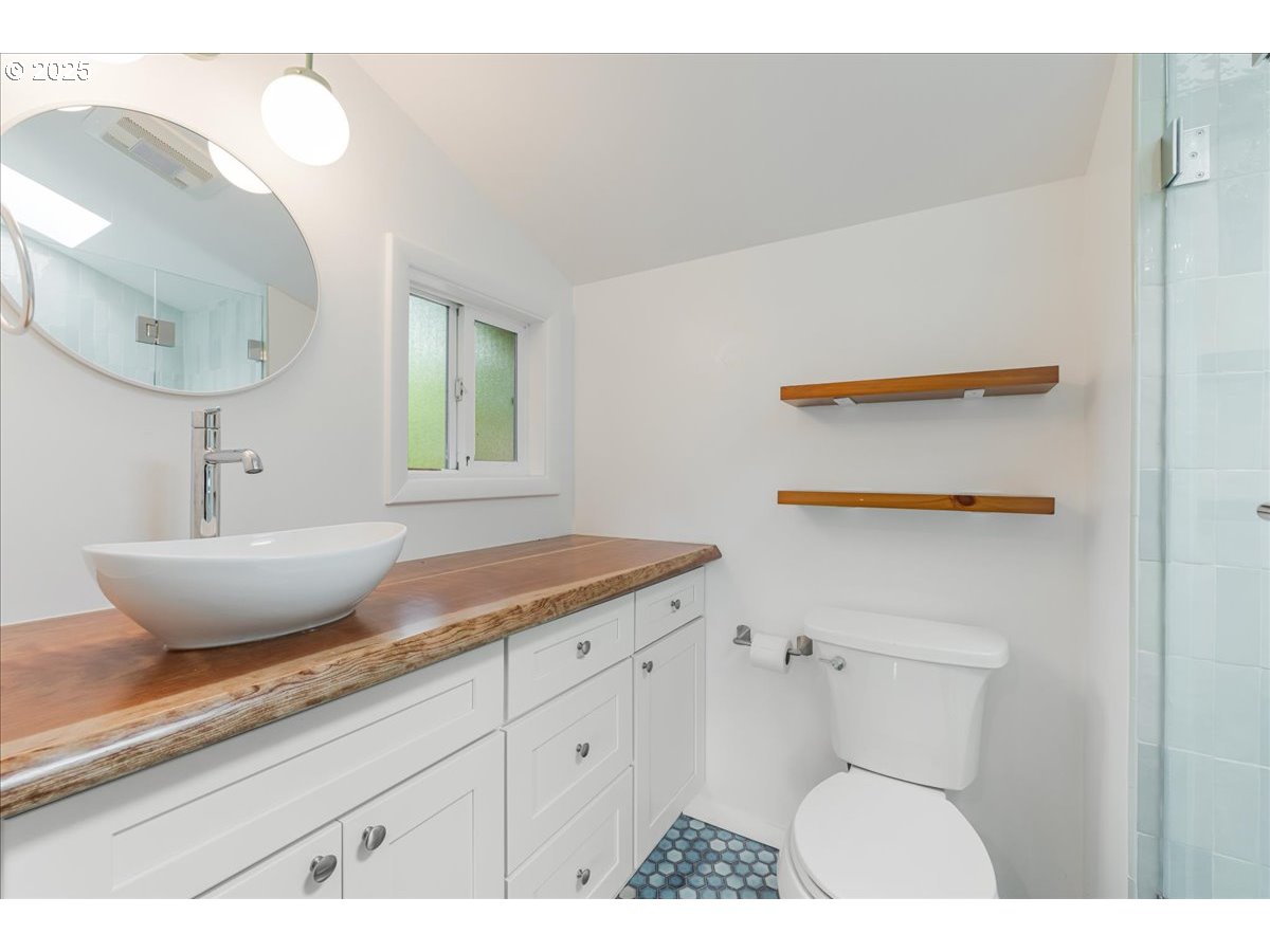 11805 Southwest Belvidere Place Portland, OR 97225 - Photo 21 of 44 a bathroom with a granite countertop sink and a mirror