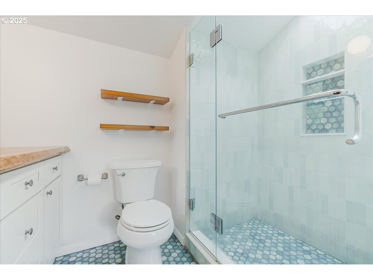 11805 Southwest Belvidere Place Portland, OR 97225 - Photo 22 of 44 a bathroom with a toilet and a shower