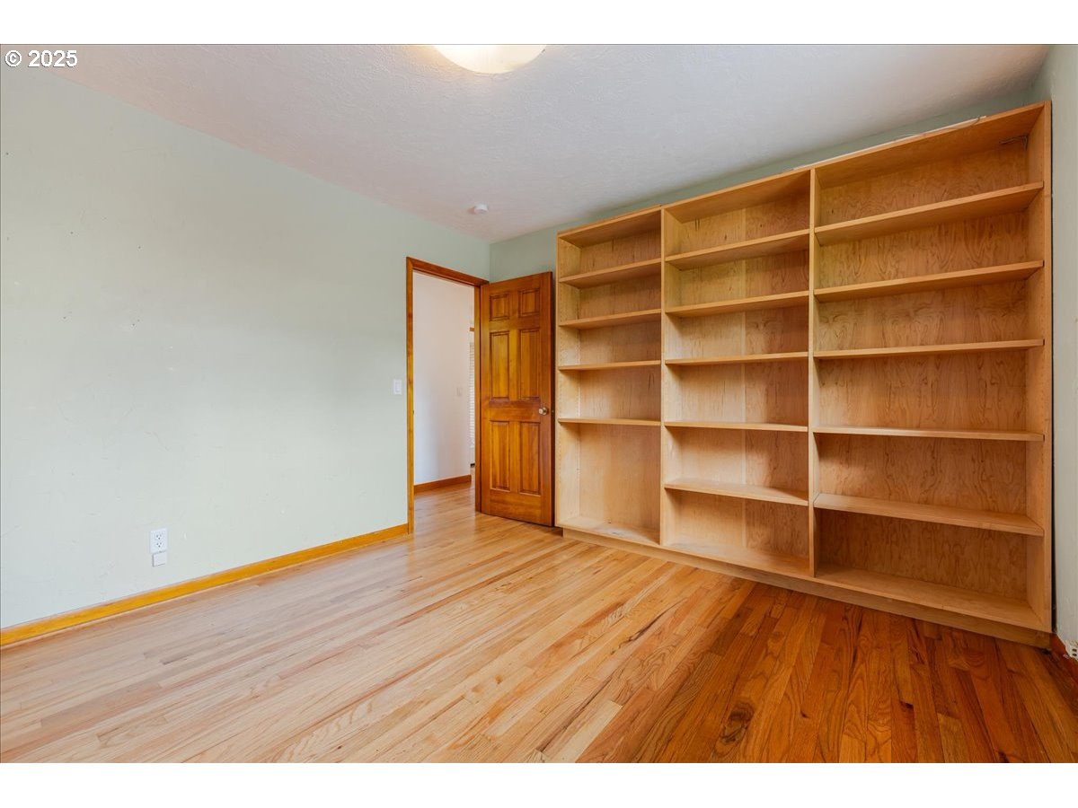 11805 Southwest Belvidere Place Portland, OR 97225 - Photo 24 of 44 a view of an empty room with wooden floor and a window