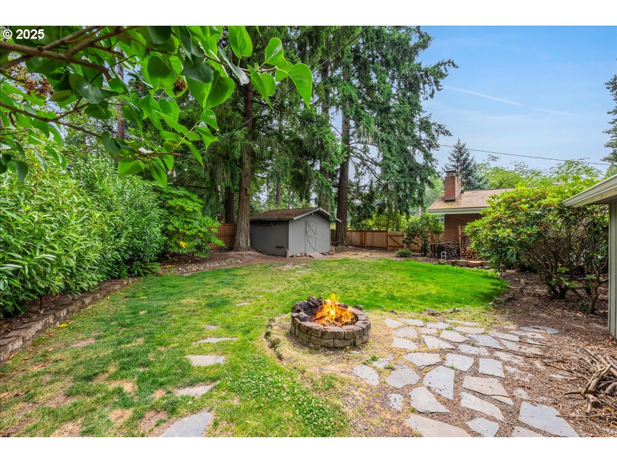 11805 Southwest Belvidere Place Portland, OR 97225 - Photo 31 of 44 a view of a backyard with table and chairs and potted plants