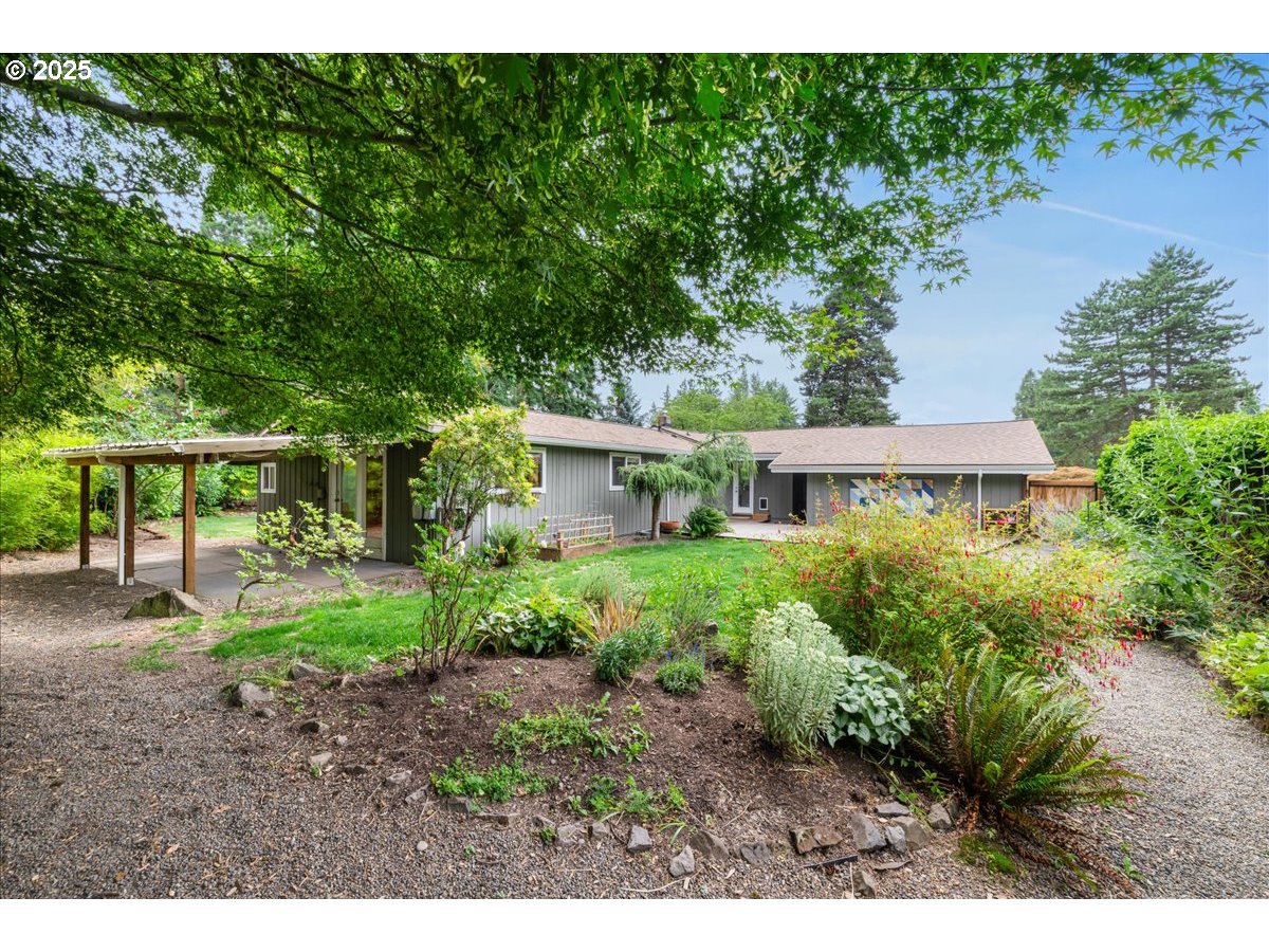 11805 Southwest Belvidere Place Portland, OR 97225 - Photo 35 of 44 a view of a house with a yard and sitting area