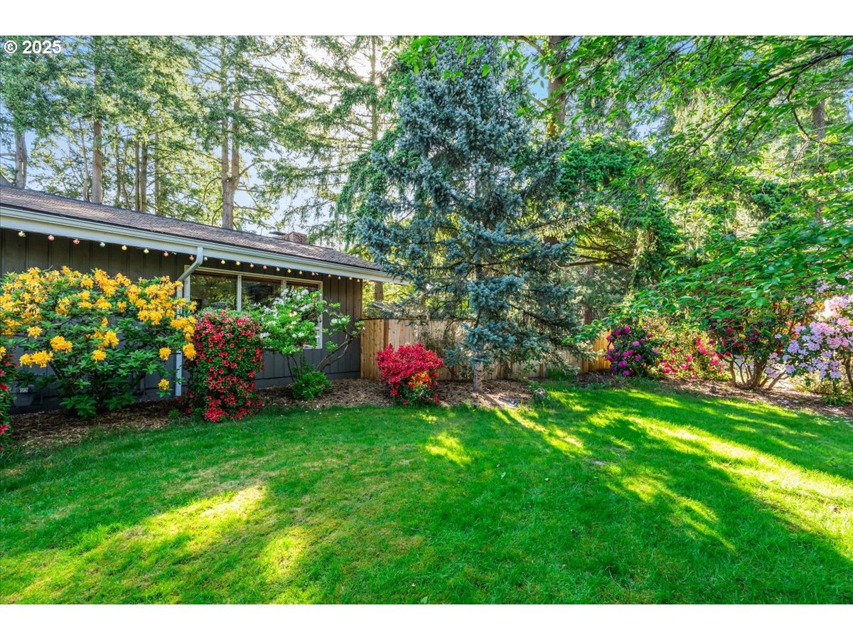11805 Southwest Belvidere Place Portland, OR 97225 - Photo 39 of 44 a view of a house with a backyard and a patio