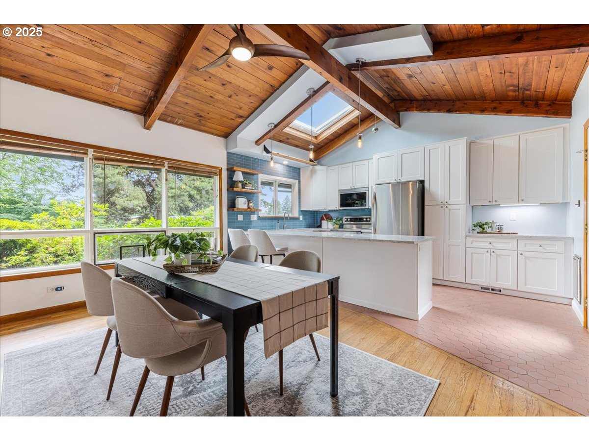 11805 Southwest Belvidere Place Portland, OR 97225 - Photo 10 of 44 a kitchen with a table chairs and wooden floor