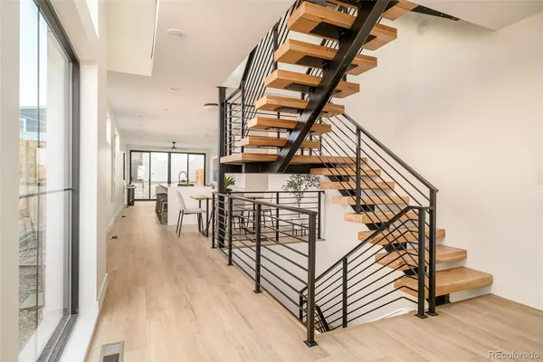 a view of entryway and hall with wooden floor