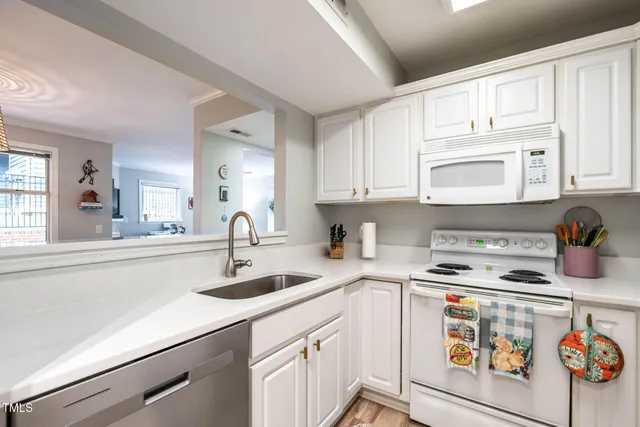 a kitchen with stainless steel appliances granite countertop a sink stove and cabinets