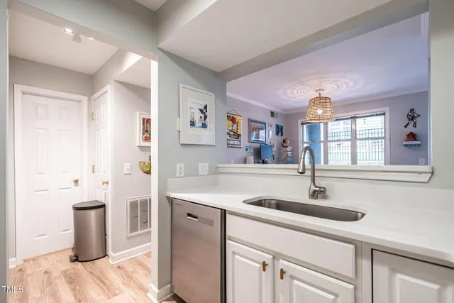 a kitchen with a sink and a refrigerator