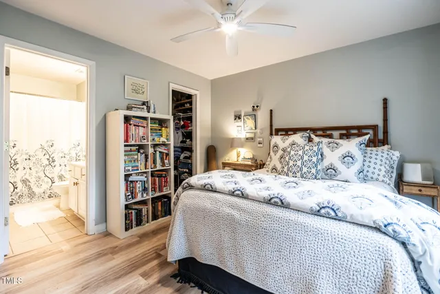 a bedroom with a bed and a book shelf