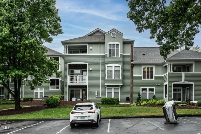 a car parked in front of a brick house