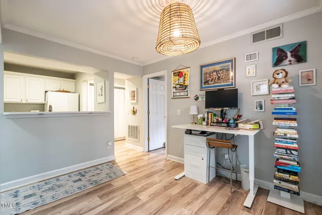 a view of a workspace with furniture and a flat screen tv