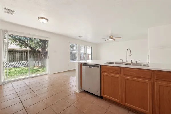a kitchen with granite countertop a stove and a sink